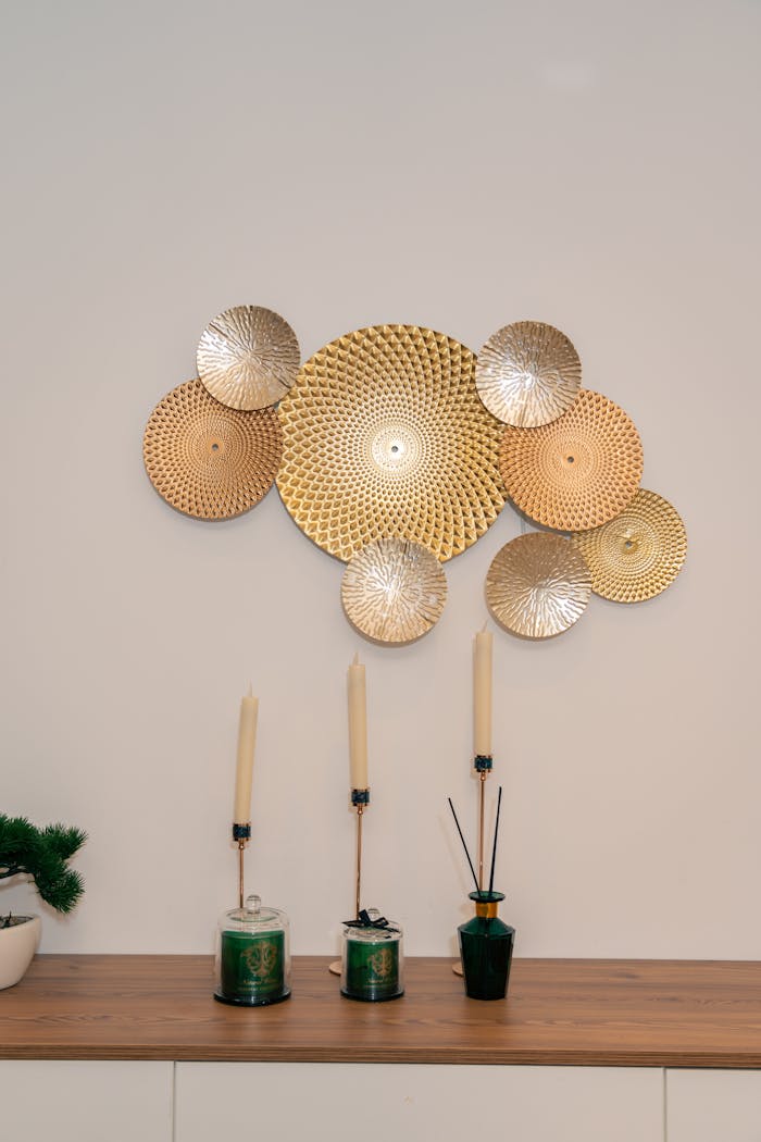 Sleek gold wall art and candles enhance a modern Dubai home interior.